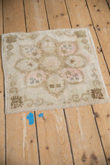 Distressed vintage Oushak corner, showing ivory, blush, even wear, and machine-bound edge.