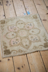Distressed vintage Oushak rug edge with faded Rococo border design.