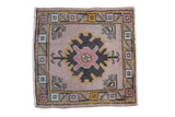 Vintage distressed Oushak square rug featuring central mauve palmette and patterned geometric border. 1'8