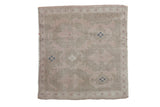 Vintage distressed Oushak square rug with a faded floral pattern in ivory, pale sage, and dusty blue.