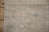 Detail of a vintage distressed Oushak rug showing even wear across the hand-knotted wool pile.