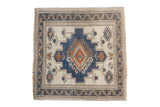 Distressed vintage Oushak square rug showcasing geometric diamond gul, ivory, dusty blue, and copper.