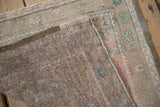 The hand-knotted back and secured side selvage of a vintage Oushak rug.