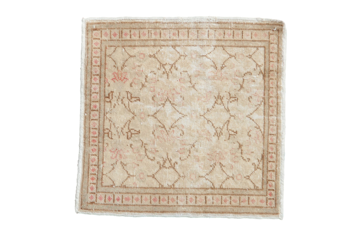 Distressed Kayseri square rug with an allover blossom pattern in ivory, sand, and dusty pink tones.