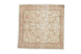 Distressed Kayseri square rug with an allover blossom pattern in ivory, sand, and dusty pink tones.