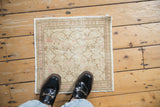A small vintage Kayseri rug with an allover blossom pattern, viewed from above for scale.