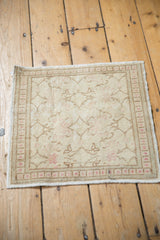The full decorative layout of a small distressed Kayseri rug mat in soft neutral tones.