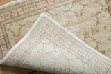 A folded corner on the vintage Kayseri rug mat reveals its hand-knotted foundation and weave.