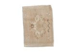 Vintage distressed Oushak bag face rug with a faded tree of life design in sand and beige.
