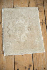 The soft, distressed texture and faded tree of life pattern on a vintage Turkish Oushak mat.