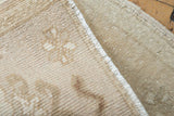 Dense hand-knotted weave and intact side cord on the reverse of a vintage Oushak rug mat.