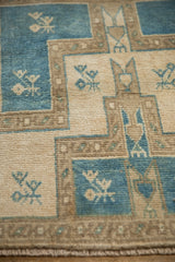 Distressed Oushak rug featuring geometric germinating tiered plant motif in dusty blue and ivory.
