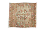Hand-knotted vintage Turkish Oushak square rug mat with distressed geometric medallion in faded beige, pink, green.