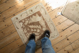 A vintage Oushak square rug mat in coffee brown and ivory, viewed from above for decorative scale.