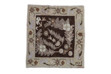 Vintage Oushak square rug with distressed, scrolled leaves on a dark brown field and beige floral border.