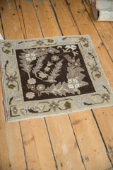 A square vintage Turkish Oushak rug showing its decorative pattern and characterful, even wear.