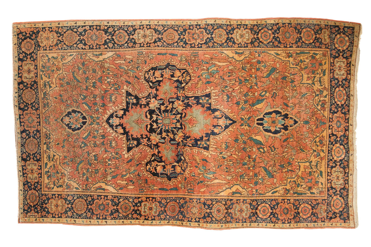 Antique Farahan Sarouk Persian rug with irregular navy medallion, terracotta field, gold, seafoam motifs. 4x6.5