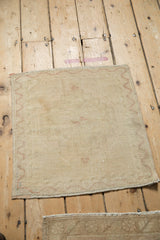 Distressed Oushak rug, showing its intact selvage and faint copper meandering vine border.