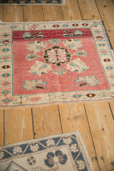 Distressed blush pink Oushak mat, showcasing floral medallion, palmette motifs, and soft faded texture.