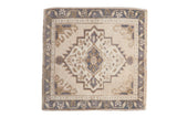 Vintage distressed Oushak rug with serrated central medallion in beige, dusty blue, and pale brown.