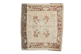 Vintage distressed Oushak mat with a quatrefoil medallion and copper arabesque borders on an ivory field.
