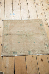 Fringe and worn cream floral border of a distressed vintage Oushak rug.