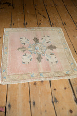 Distressed Oushak corner with dusty rose field, antique ivory border, and sky blue motifs.
