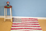 Folk art vintage American Flag rag rug, hand-knotted red and cream stripes, frayed top edge.