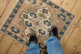 Border detail of vintage distressed Oushak rug with cobalt blue flowers and abrashed field.