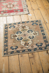 Distressed Oushak rug corner, cobalt blue floral border, abrashed field, even wear.