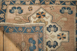 Textured cobalt blue border and hand-knotted reverse of a distressed vintage Oushak rug.
