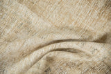 Distressed Oushak rug close-up: visible pile wear, abrash, beige, sand, and cream tones.
