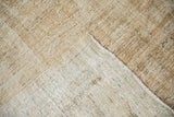 Light beige distressed Oushak carpet pile showing knot heads and hand-knotted foundation.