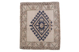 Distressed Oushak square rug with a cobalt blue diamond gul and beige vine border.