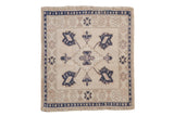 Vintage Oushak square mat with a diamond medallion and blossoms in dusty navy blue, ivory, and beige tones.