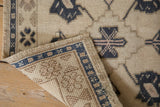 Corner detail of a vintage Oushak rug showing the secured side cord and hand-knotted foundation.