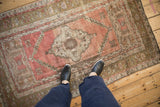 Distressed Anatolian rug corner, blush field, pale bronze border with serrated floral blossoms.