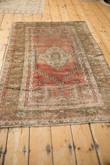 Distressed vintage Anatolian rug corner with faded blush and serrated floral blossoms.