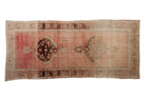 Distressed Oushak runner, double medallions with palmette finials, in faded rose, aubergine, and beige.
