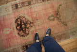 Distressed vintage Oushak runner, serrated medallion on a pale rose abrashed ground.