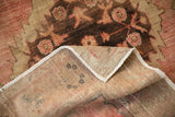 Folded corner of Vintage Distressed Oushak rug runner reveals hand-knotted foundation and painted numbers.