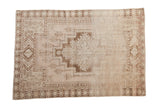 Distressed vintage Oushak rug featuring geometric medallion in chocolate brown and ivory-beige, 4'1