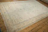 Distressed ivory and dusty powder blue tones along the border of the vintage Sparta carpet.