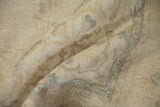Distressed vintage Sparta rug detail with worn pile, foundation showing, in muted beige and blue.