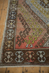 Distressed Oushak runner's chocolate brown geometric border with faded terracotta field.