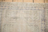 Distressed vintage Oushak rug pile showing wear to knot heads and cream tones.