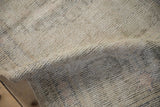 Textural close-up of decorative distressed cream and ivory pile on a vintage Oushak rug.