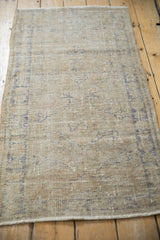 Distressed texture and faded royal blue scrolling vines on vintage Oushak rug runner.