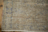 Distressed vintage Oushak rug pile texture, revealing knot heads and foundation wear.