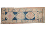 Distressed Oushak runner, cobalt blue and dusty pink hook and latch medallions.